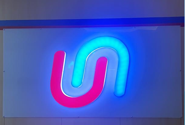 Retail storefront branding project in Udupi with illuminated channel letters and window graphics